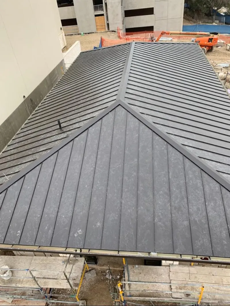 Commercial metal roof construction with crane equipment in Scarsdale