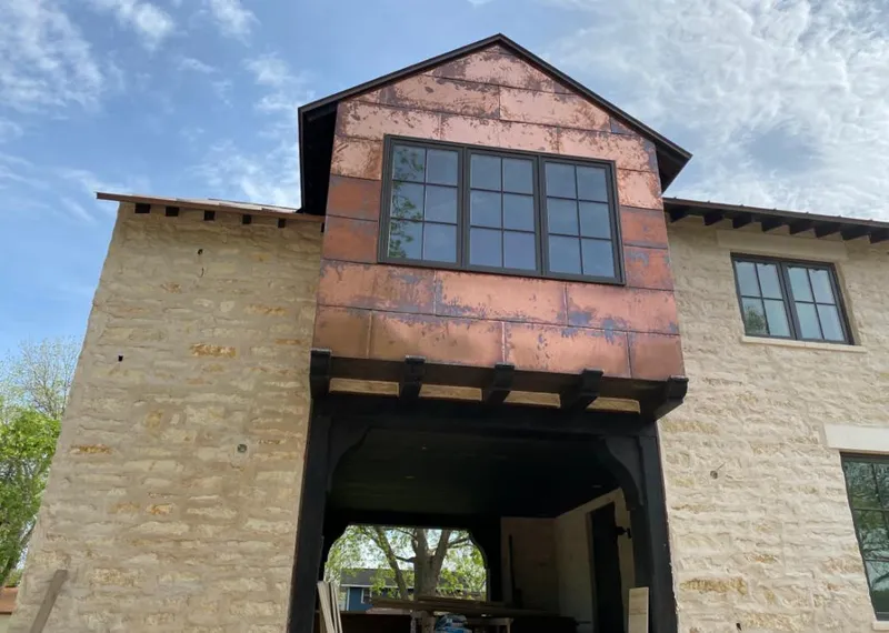 Copper metal panel facade on a stone building for Roof Repair in Scarsdale
