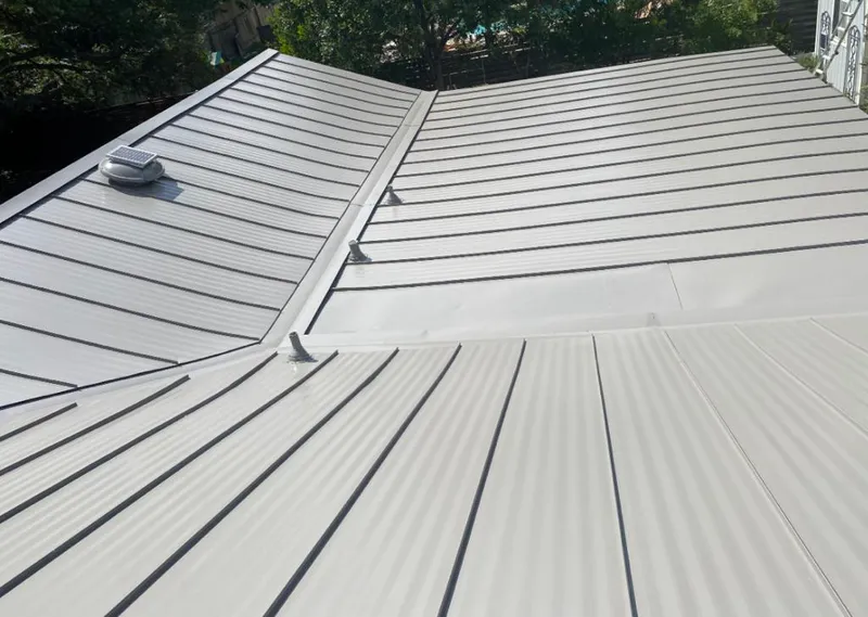Solar attic fan installed on a metal roof for Roof Ventilation in Scarsdale